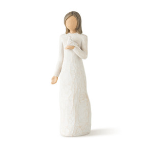 Front view of standing female figure with shoulder length brown hair wearing cream dress, holding white dove on hand