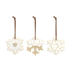 Three white and gold snowflake shaped ornaments.