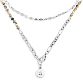 A silver wrap necklace/bracelet with various gold and silver beads, and a circular pendant with a star shape cutout.