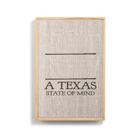 A light wood framed wall art that says "A Texas State of Mind" on a wood grain background under two black lines for personalization.