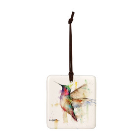 A square hanging ornament with a watercolor image of a hummingbird in flight.