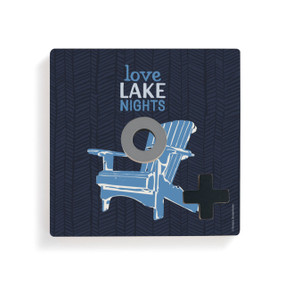 A dark blue square board with a blue Adirondack chair and the saying "Love Lake Nights" for tic tac toe with a gray O and black X on top.