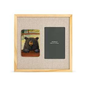 A light wood frame with a painted tile on the left showing a black bear peeking through a window, next to a 4x6 photo opening with a linen mat.