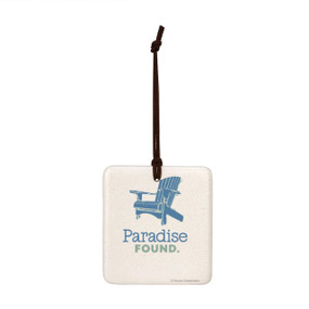 A square hanging ornament with a blue Adirondack chair that says "Paradise Found".