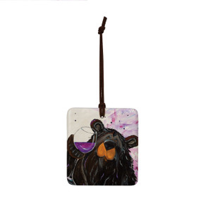 A square ceramic hanging ornament with a painting of a black bear holding a glass of wine.