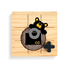A square wood tic tac toe board with a black bear looking over a tree stump with Colorado on it, with a gray O and black X on top.