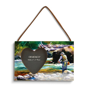 A rectangular wood hanging frame with a heart shaped 2 inch photo opening next to a watercolor image of a man fishing in a river.