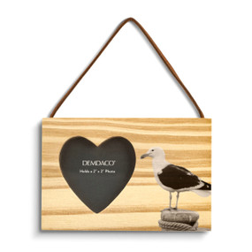 A rectangular wood hanging ornament with a heart shaped 2 inch photo opening next to an image of a sea gull.