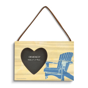 A pale yellow rectangular hanging wood frame with a 2 inch heart shaped opening for a photo next to an image of a blue Adirondack chair.