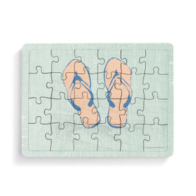 A rectangular wood 24 piece postcard puzzle with a pair of flip flops on a light green background.