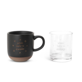 A black mug with a textured base that says "when baby is awake" and a clear whiskey glass that says "when baby is asleep".