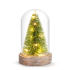 A glass dome cloche with a wood base and a green bottle brush tree inside that is lit and sprinkled with snow.