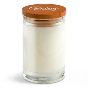 A white round glass White Lavender scented candle with a wood lid that says "Giving Collection" on top.