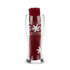 A clear pilsner glass that says "Be Of Good Cheer" with a Burgundy towel rolled and standing in the glass.