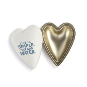 A white heart shaped container that says "Life is Simple. Just Add Water." in blue with the lid offset to the base.