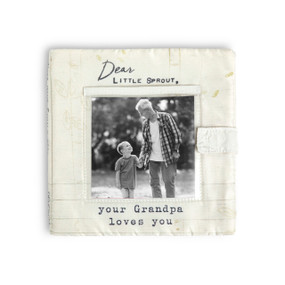 A cream fabric photo book with a photo opening on the front and says "Dear Little Sprout, your Grandpa loves you".