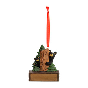 A hanging ornament of two black bears peeking around a tree on a rectangular base that can be personalized.