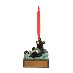 An ornament of a black bear in the water catching a fish, hanging from a red ribbon. There is a spot in front for customization.