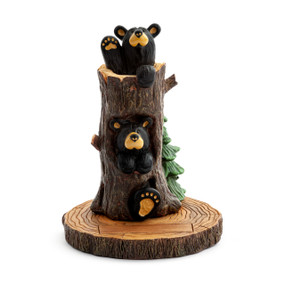 A figurine of a upright hollow tree stump with two little bears peeking out. The figurine has a space for customization.