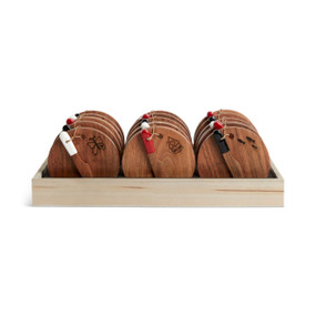 A table top wood tray displayer with an assortment of round wood serving boards with wood spreaders attached.