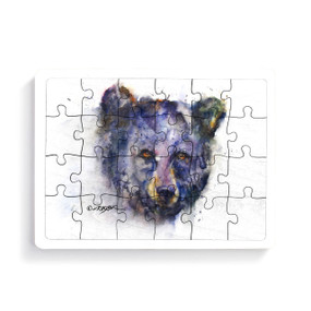 A 24 piece puzzle postcard with the watercolor image of a determined bear's face.