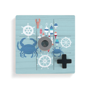 A square blue wood board for tic tac toe with an illustration of buoys, crabs and ships wheels, displayed with a gray O and black X on top.