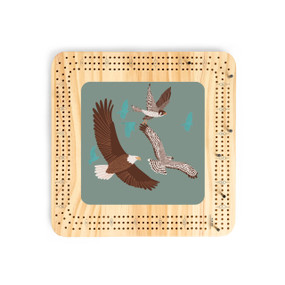 A light wood cribbage board with an illustration of birds in flight.