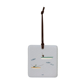 A square light gray hanging tile magnet ornament with an illustration of fish and fishing boats.