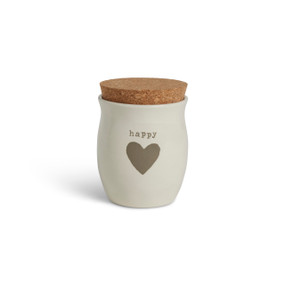 A cream ceramic candle with a gray heart and the word "happy". The candle has a cork lid.