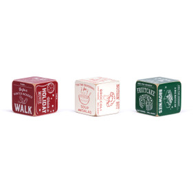 A set of three red and green painted wood dice with instructions on them for a holiday dinner, dessert and activities.