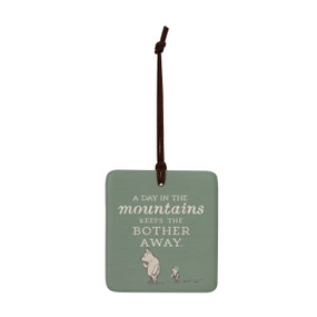 A square green hanging tile magnet ornament that says "A Day in the mountains Keeps the Bother Away" with an image of Pooh and Piglet.
