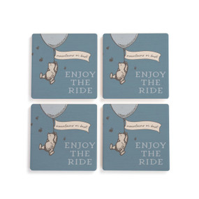 A set of four blue square ceramic coasters that say "Enjoy The Ride" with Pooh hanging on a balloon that says "mountains or bust".