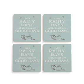 A set of four blue square ceramic coasters that say "Even Rainy Days at the beach are Good Days" with an image of Eeyore.