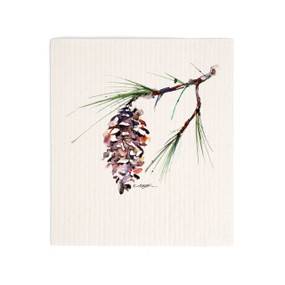 A white biodegradable dish cloth with a watercolor image of a white pine branch.