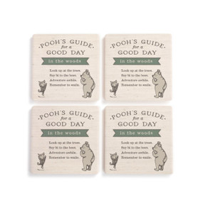 A set of four cream square ceramic coasters that say "Pooh's Guide for a Good Day in the woods" with an image of Pooh and Piglet.