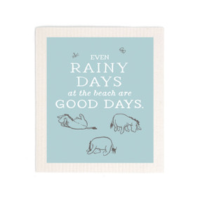 A light blue biodegradable dish cloth that says "Even Rainy Days at the beach are Good Days." with three images of Eeyore.