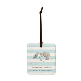 A square light blue and white striped hanging tile magnet ornament that says "The best thing," said Pooh, "is a day at the beach with you." with an image of Pooh and Piglet at the beach.