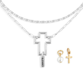 A silver chain necklace with an open cross that is used to place other charms on.