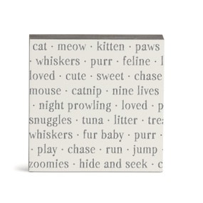 A white square wall art with words about cats on it.