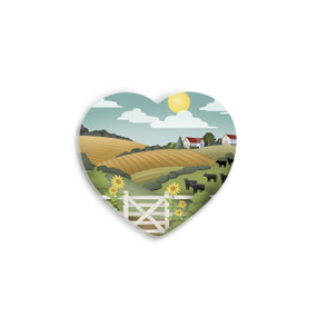 A set of four heart shaped ceramic coasters with graphic artwork of a hilly farmstead and pasture.