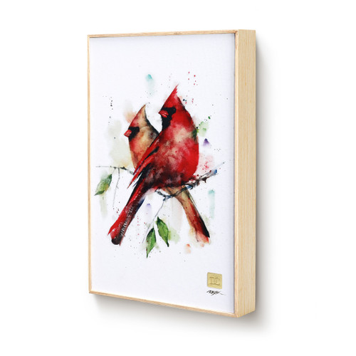 A light wood framed watercolor image of a pair of cardinals perched on a branch, displayed angled to the left.
