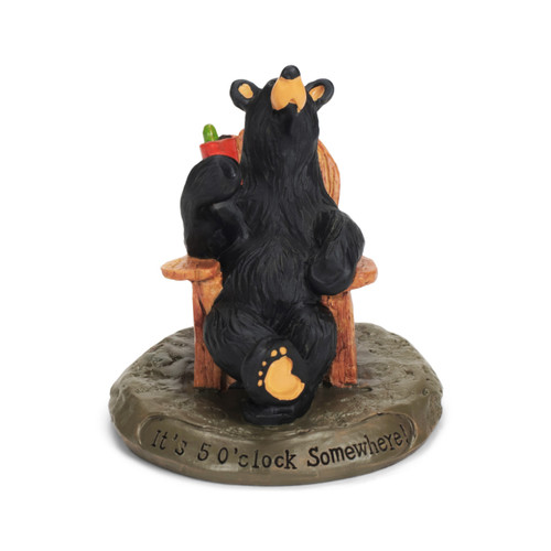 Front view of a small black bear figurine holding red cup with lime - sitting in wood chair on a round base that says "Its 5 o clock somewhere'"