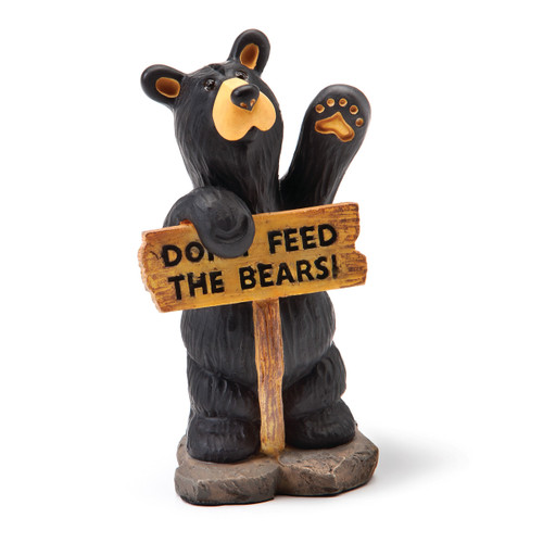 Black bear figurine standing up holding wooden sign that says 'dont feed the bear's
