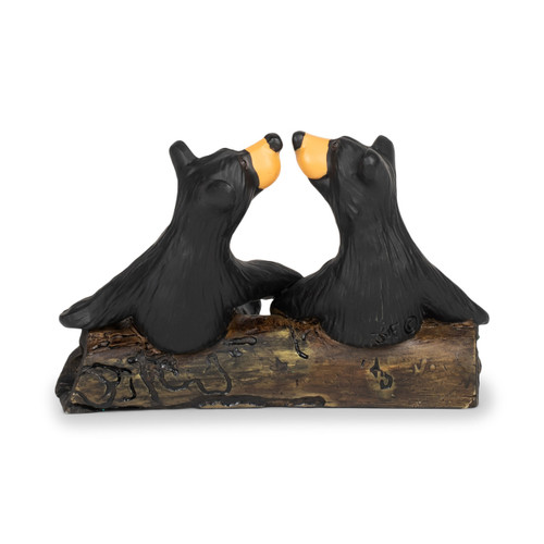 Back view showing a figurine of two black bears sitting on a fallen log looking at each other with their noses almost touching.