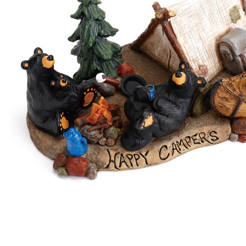 Close view of black bears sitting around fire and campside - 'happy campers' carved in on the bottom