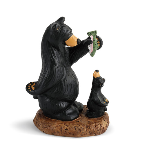 sculpture of parent black bear holding fish over young black bear's head