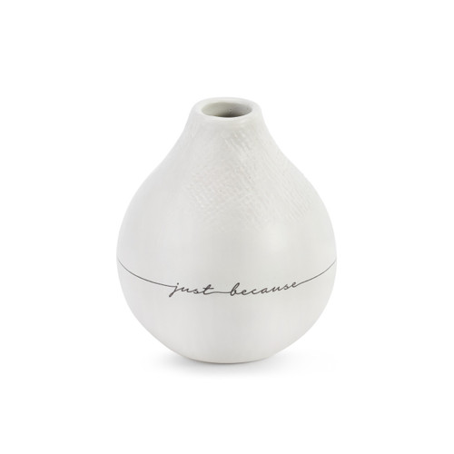 A textured white circular vase with "Just Because" engraved.