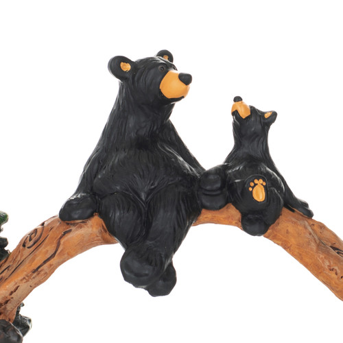 Detail view of the bears on a wood bridge figurine with a large and small black bear sitting together on it.