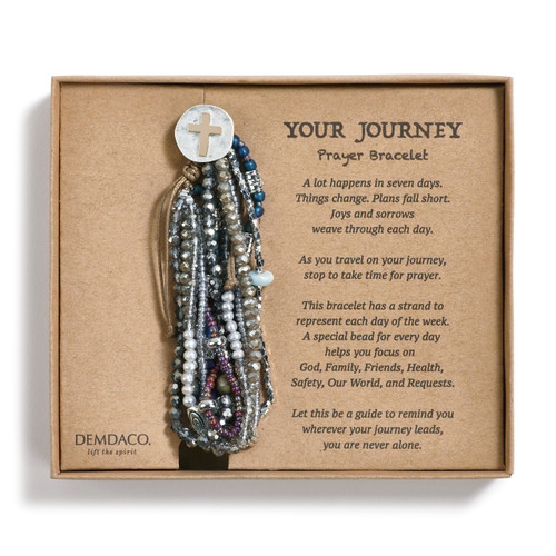 Bracelet with seven strands consisting of pearls, gemstones, and glass beads is multi-colored. Large silver pendant with gold cross on bracelet. Bracelet is in brown gift packaging with black lettering
