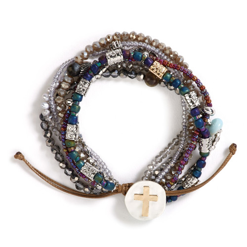 Bracelet with seven strands consisting of pearls, gemstones, and glass beads is multi-colored. Large silver pendant with gold cross on bracelet.